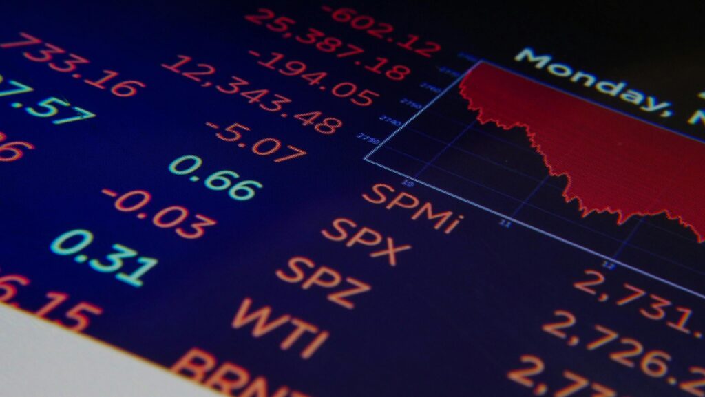 Black and blue digital screen showing falling stock market prices